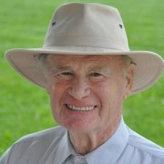 Smiling white-haired man wearing a panama hat